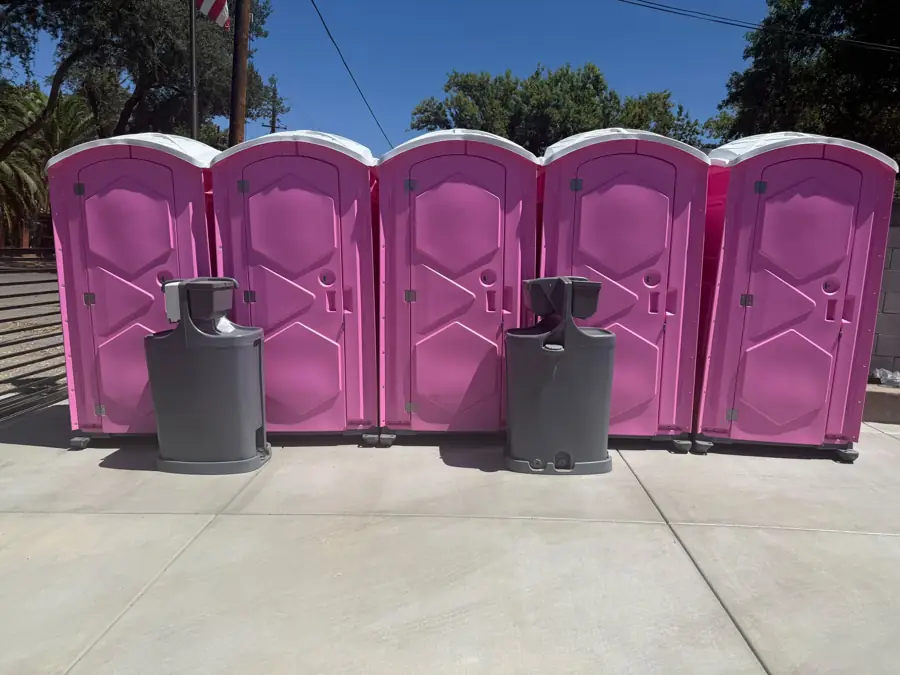 Event porta potties and hand washing stations set in bright summer sun