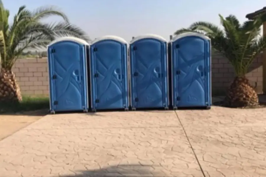 Row of blue event porta potties lined up for a public event